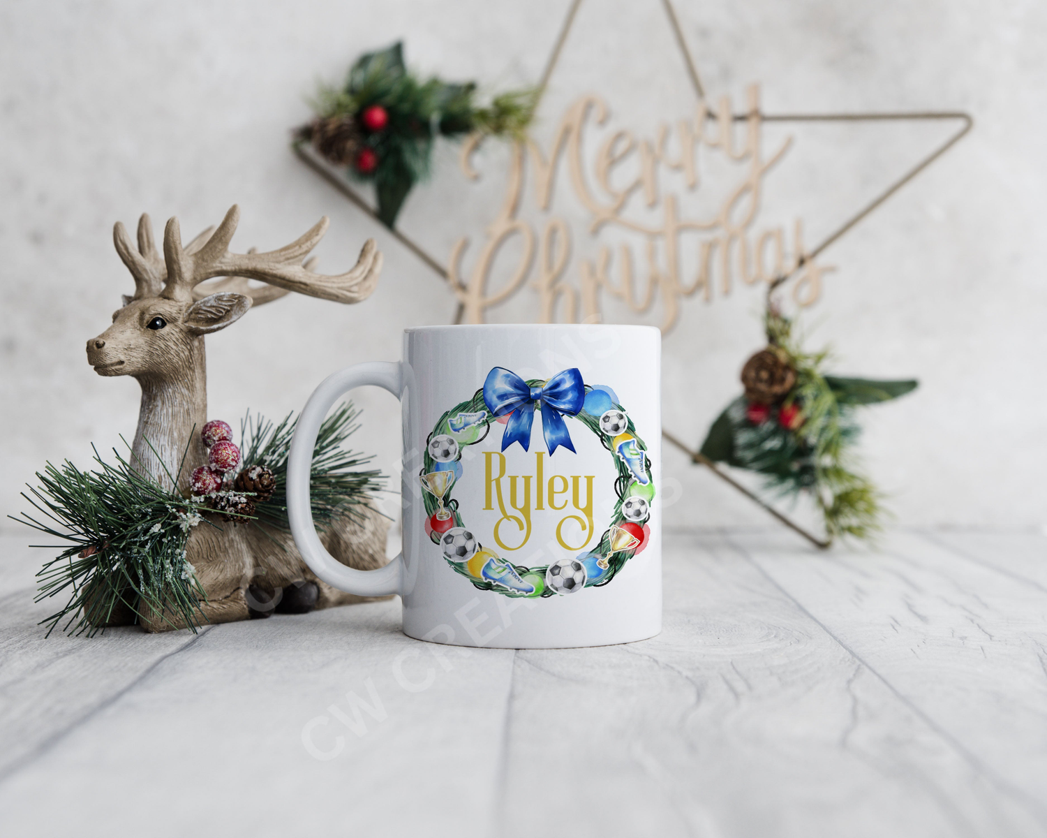 White mug featuring a christmas wreath decorated with footballs and a blur ribbon.