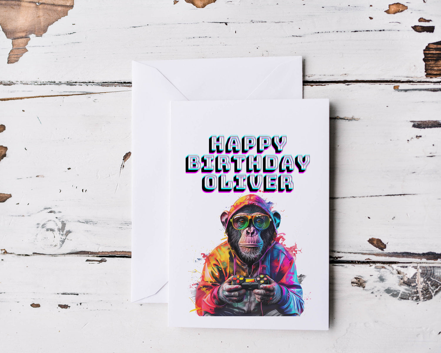 A white card with a monkey wearing glasses holding a gaming controller with the words Happy Birthday Oliver