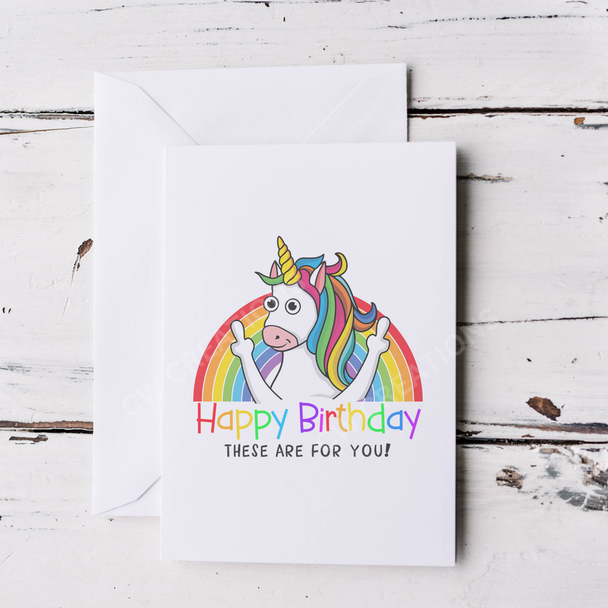 White card with bright colours a unicorn standing in front of rainbow sticking middle fingers up. Reading the words Happy Birthday These Are For You!