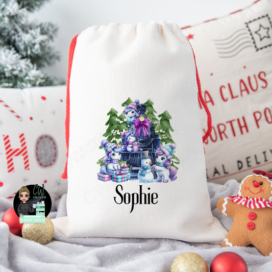 A linen Christmas sack with a Unicorn train personalised with a name.