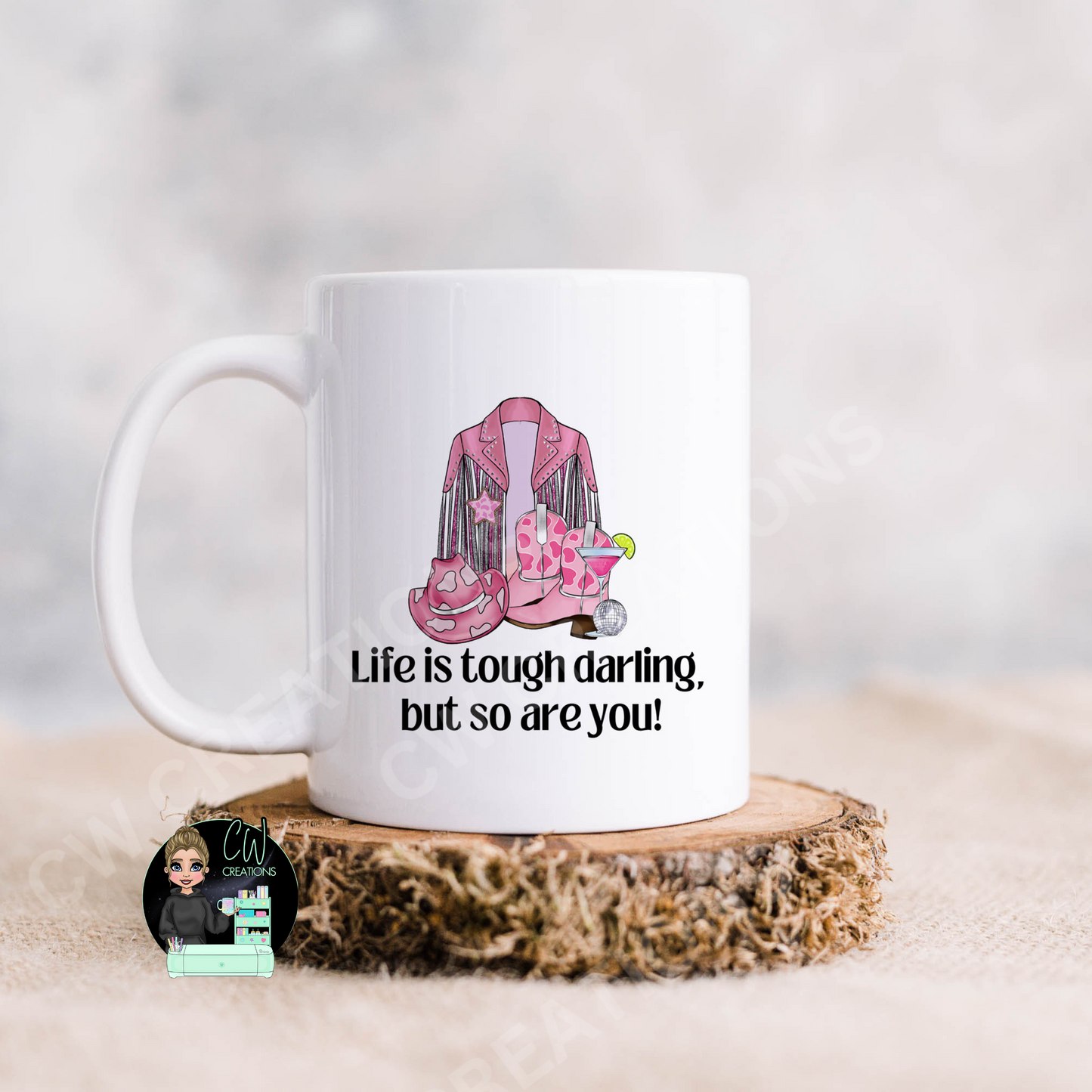 A white coffee mug featuring the quote: "Life is tough darling,but so are you"