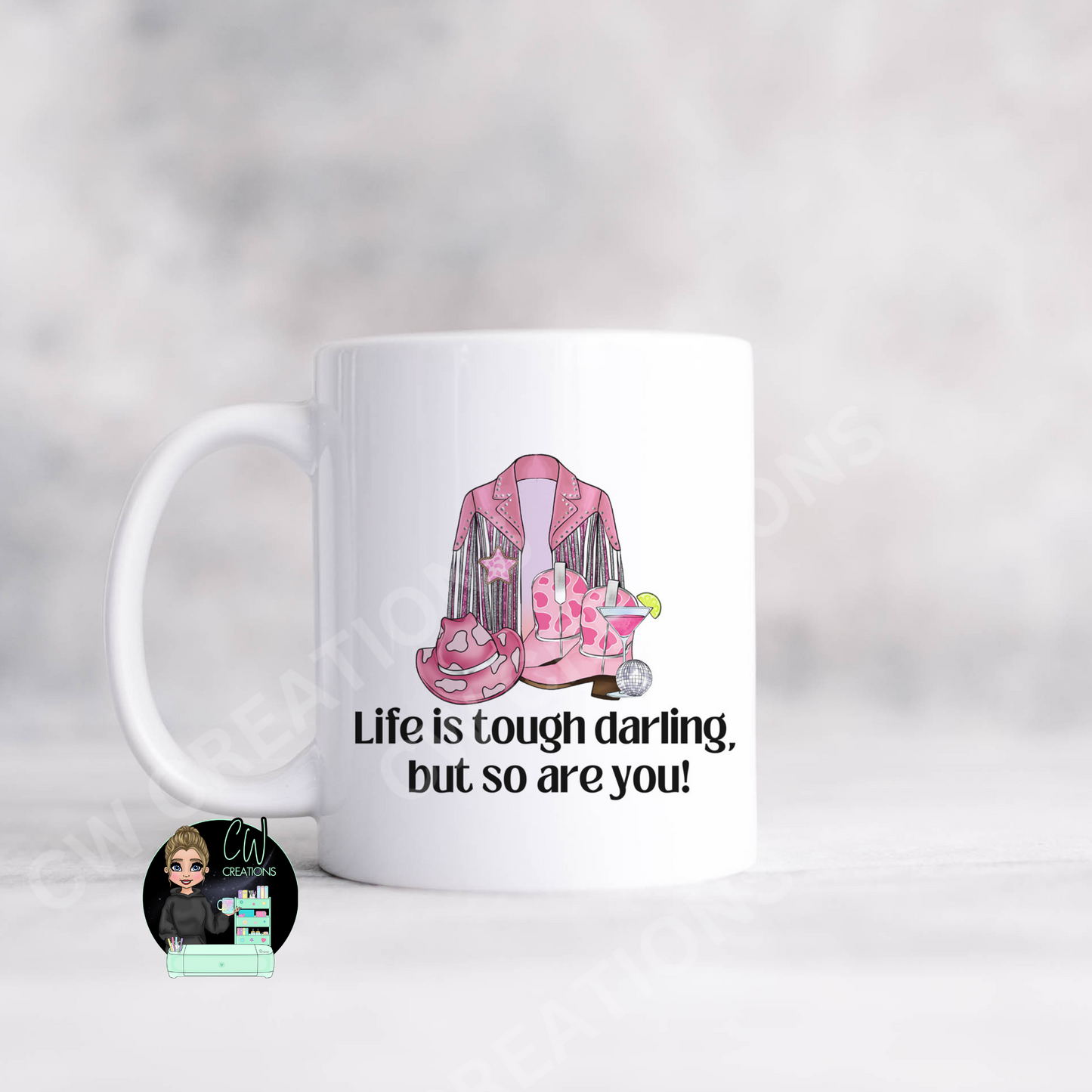 A white coffee mug featuring the quote: "Life is tough darling,but so are you"