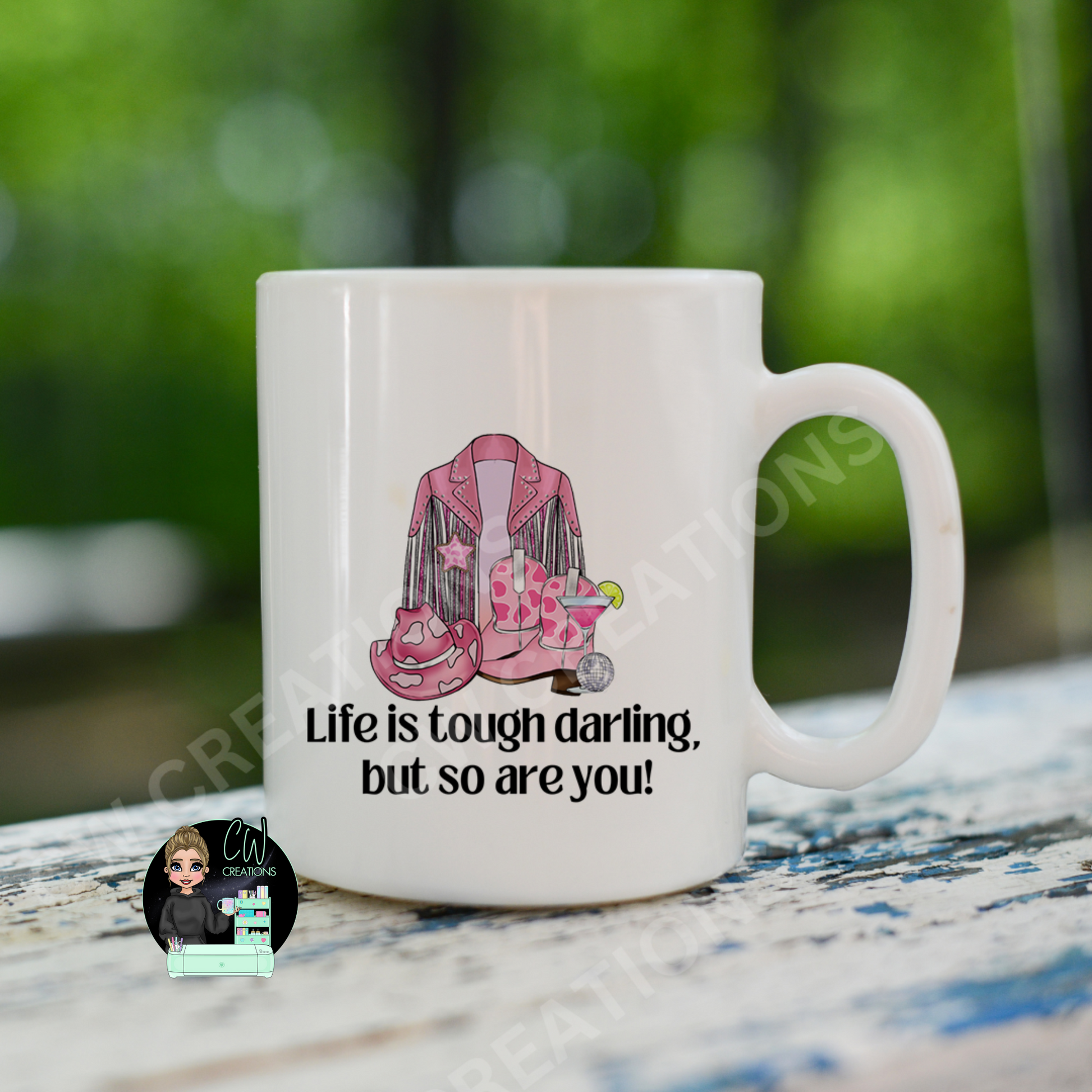 A white coffee mug featuring the quote: "Life is tough darling,but so are you"