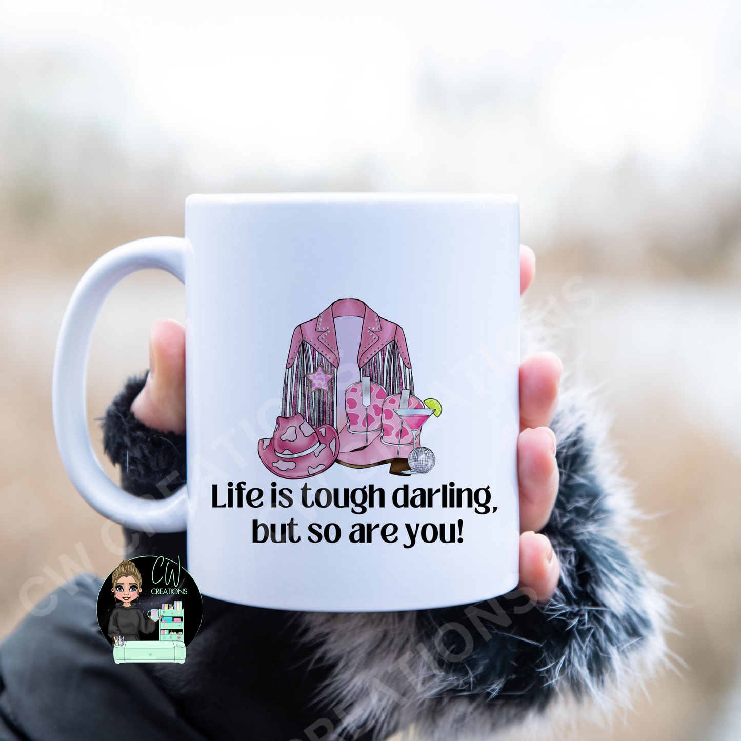 A white coffee mug featuring the quote: "Life is tough darling,but so are you"