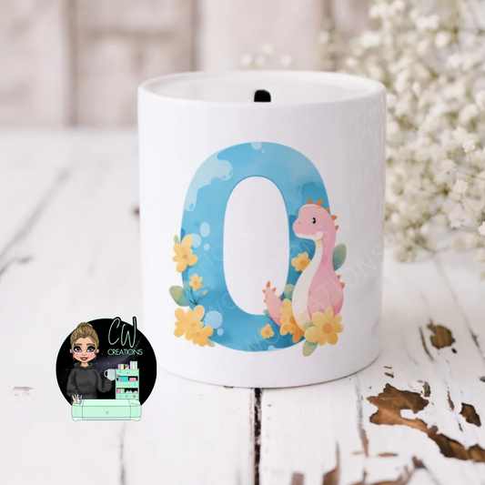 A white money box the letter O and a dinosaur and flowers