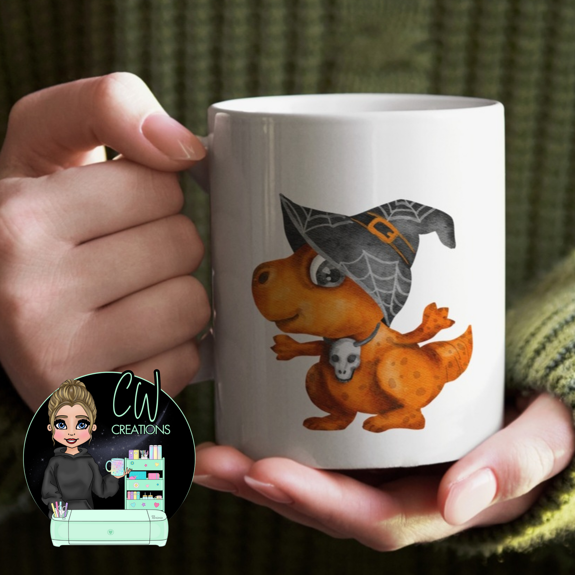 A white mug with an orange dinosaur wearing a witches hat