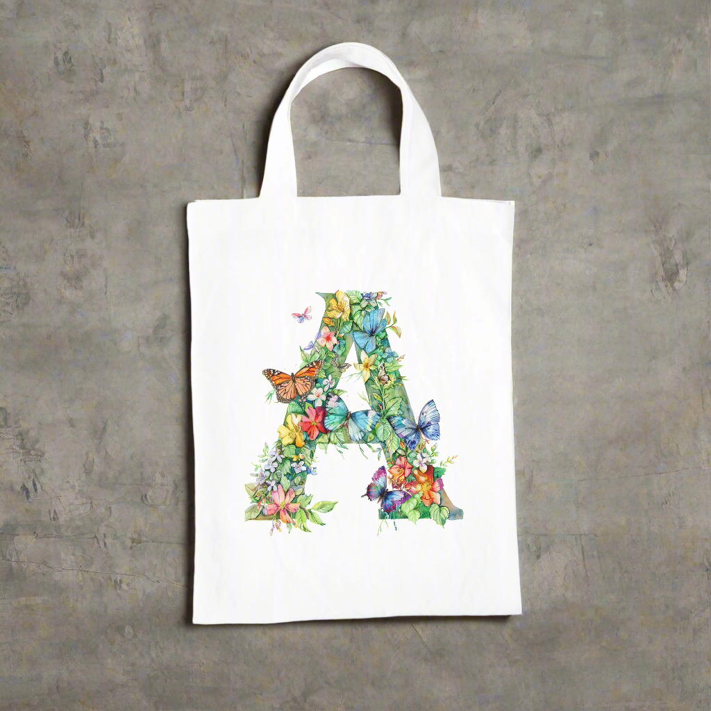 A white bag with the capital letter A covered in flowers and butterflies.