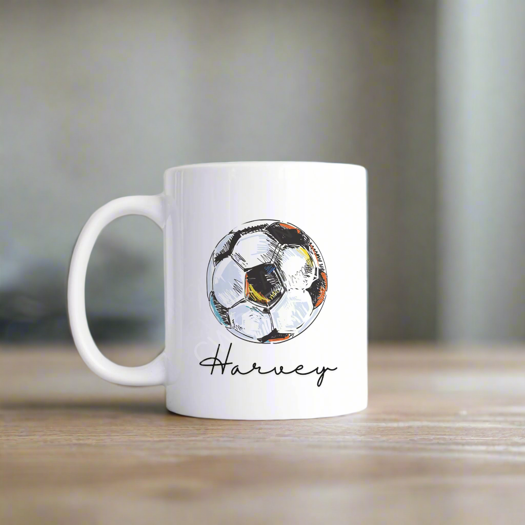 A white mug with a football graphic personalised with a name.