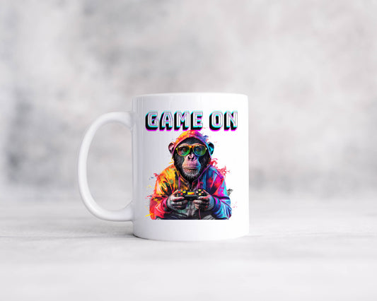 A white mug with the words Game On featuring a mug holding a controller.