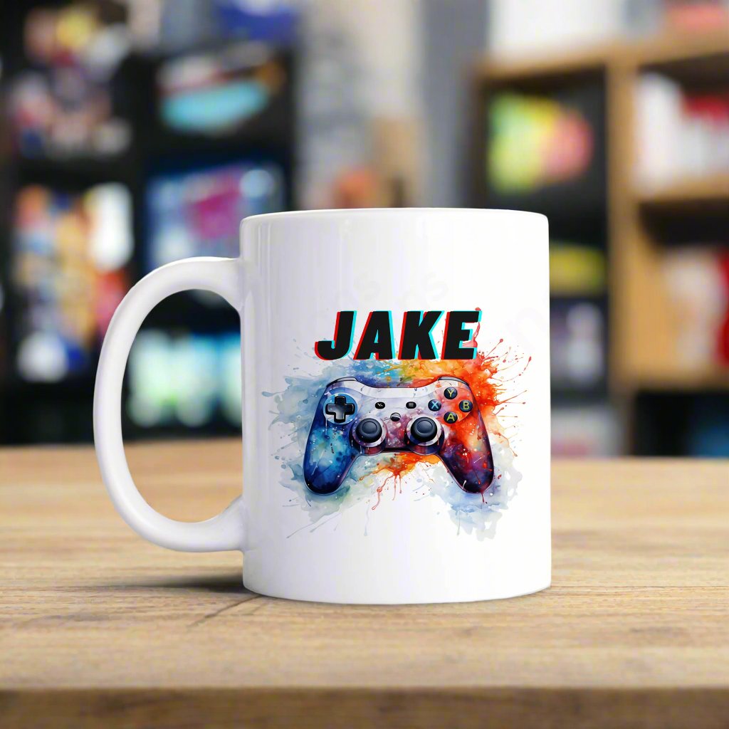 a white mug with a white controller and watercolour splashed paint personalised with a name.