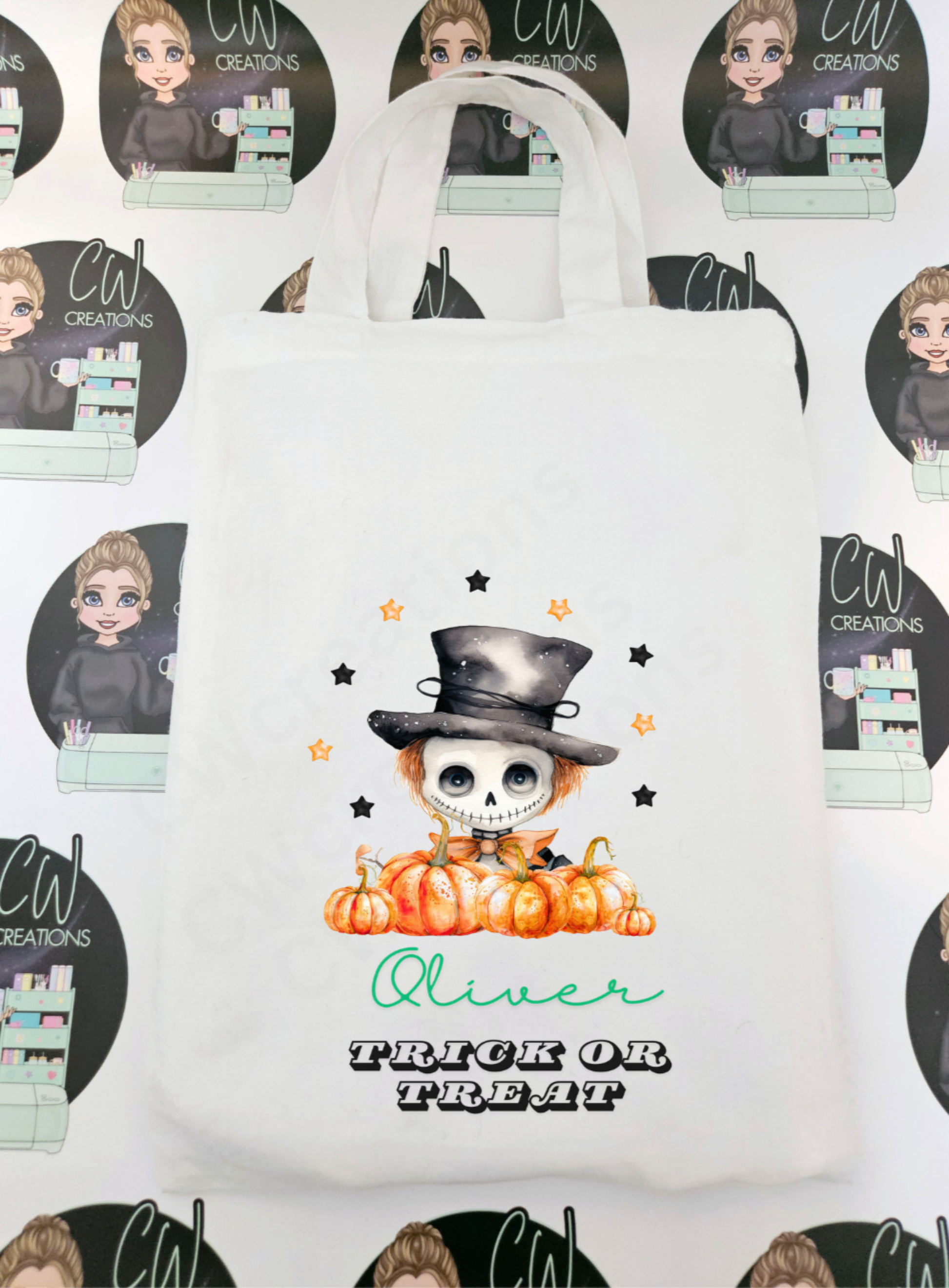 A white bag with a skeleton pumpkin and stars personalised with a child name.