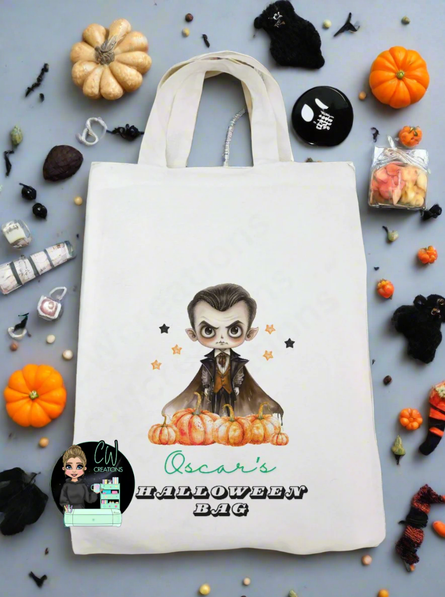 A white bag with a vampire pumpkin and stars personalised with a name with the words Halloween bag.