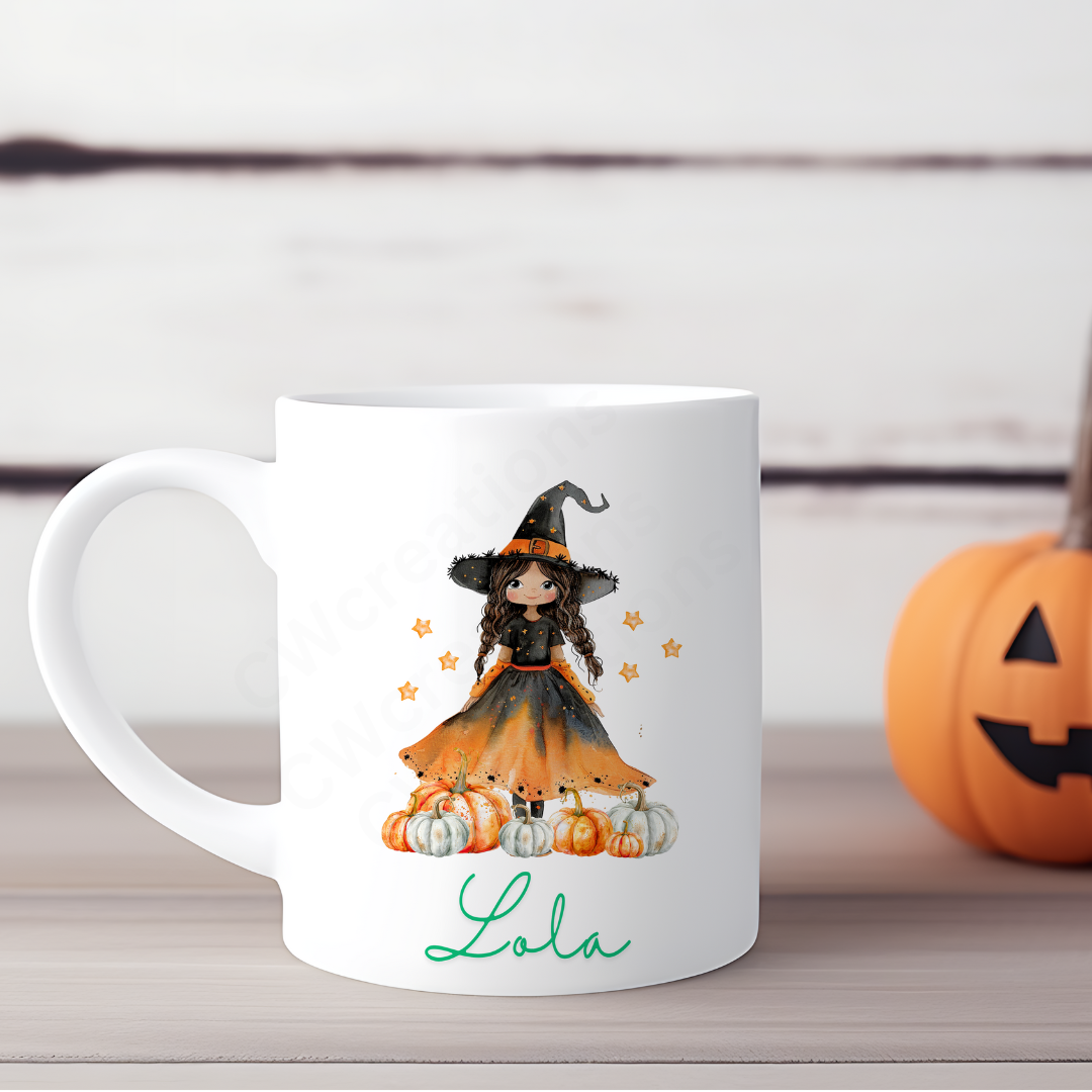 A white mug with a witch pumpkin and stars personalised with a name.