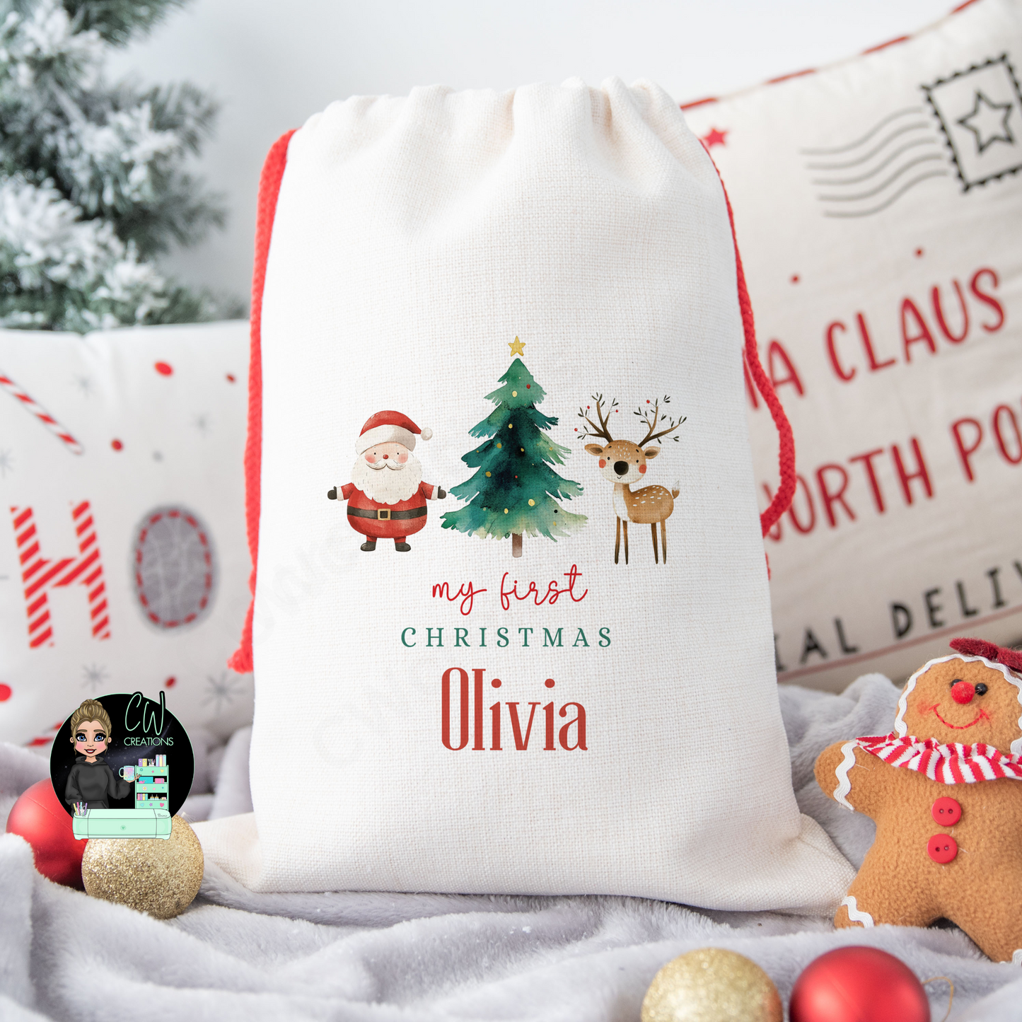 A linen Christmas sack with a graphic of Santa Claus, a Christmas Tree and a Reindeer with the words my first Christmas personalised with a baby's name.