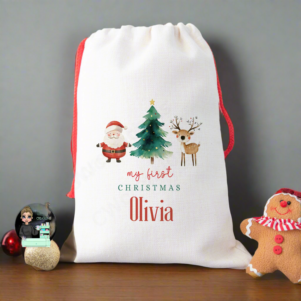 A linen Christmas sack with a graphic of Santa Claus, a Christmas Tree and a Reindeer with the words my first Christmas personalised with a baby's name.