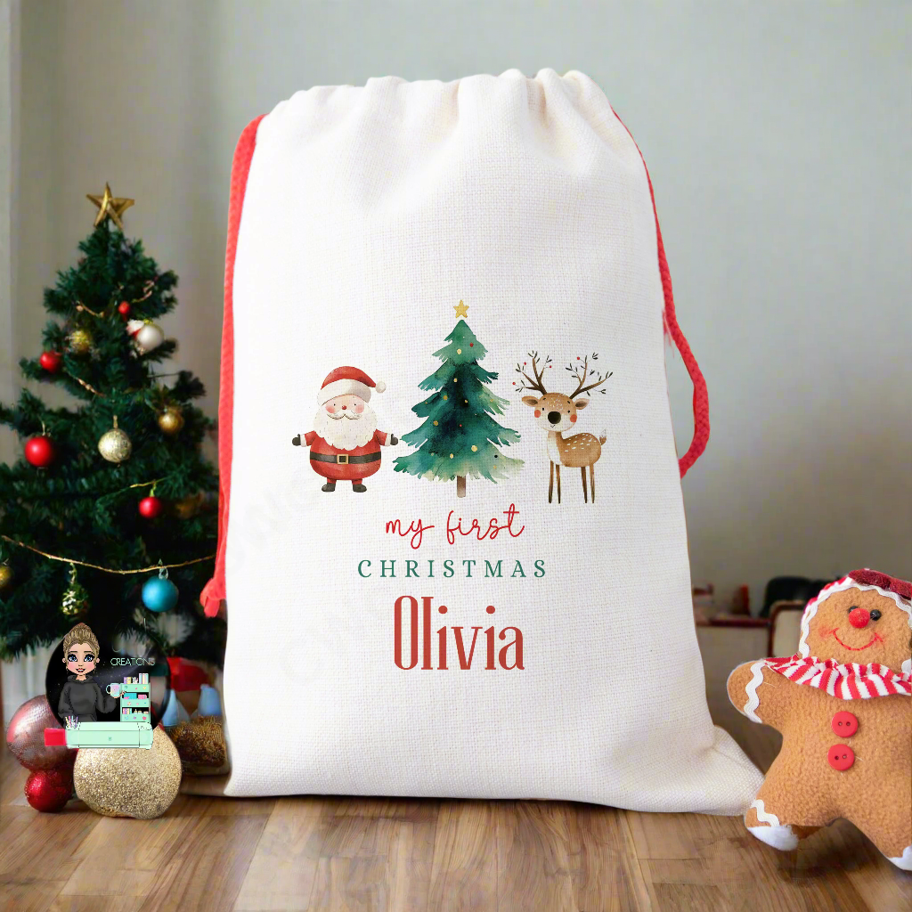 A linen Christmas sack with a graphic of Santa Claus, a Christmas Tree and a Reindeer with the words my first Christmas personalised with a baby's name.