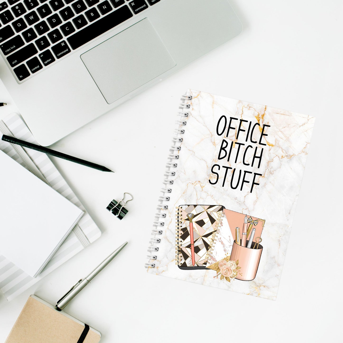 A notebook with a marble effect background and notebook graphics with the words Office Bitch Stuff.