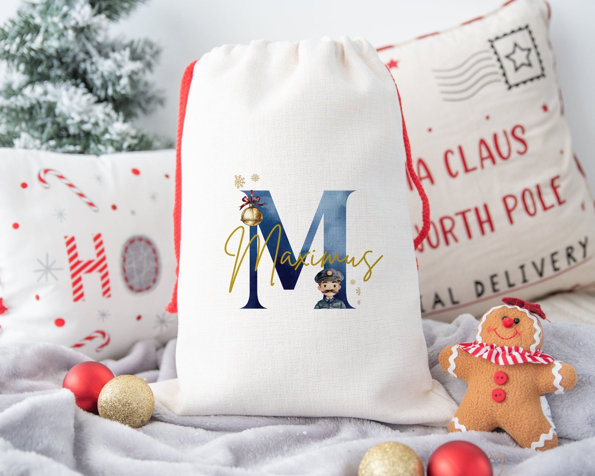 A linen Christmas sack personalised with a initial and a name with the image of a bell and a train conductor.