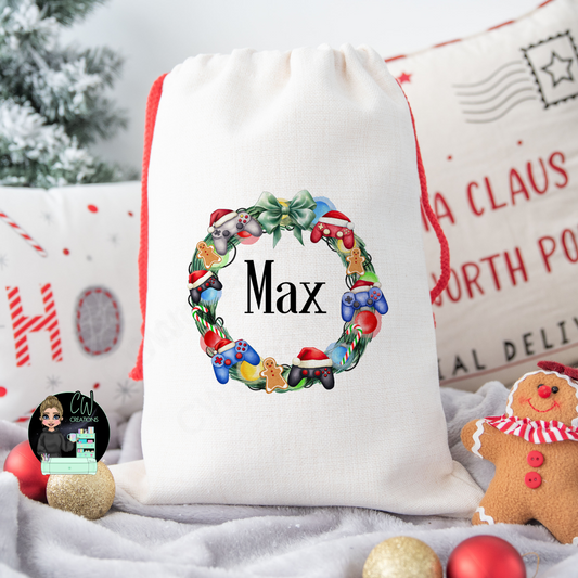 A linen Christmas sack with a gaming controller wreath personalised with a name