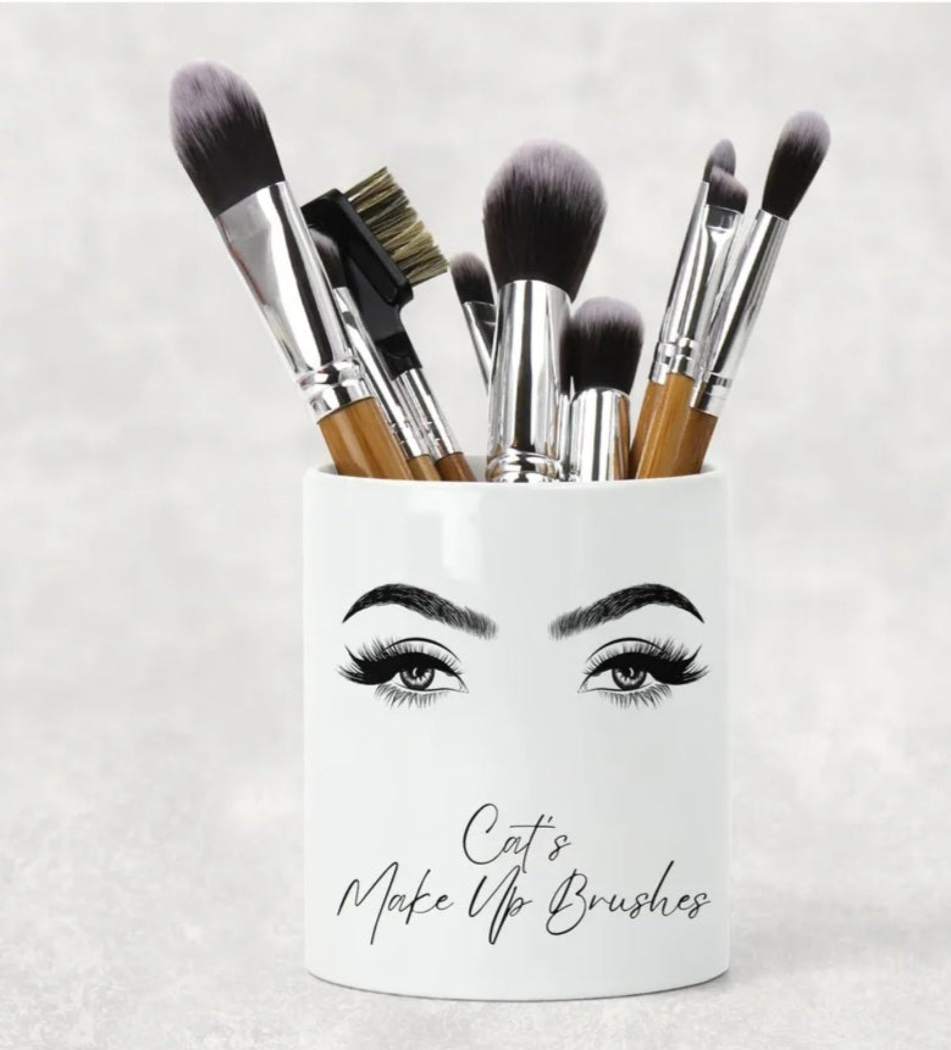 A white ceramic make up brush holder personalised with a name and the words Make Up Brushes