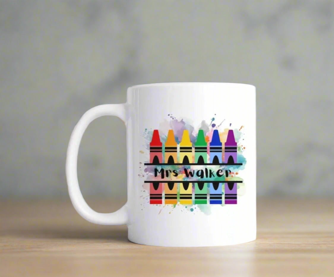 A white mug with paint splashes crayons personalised with a teachers name