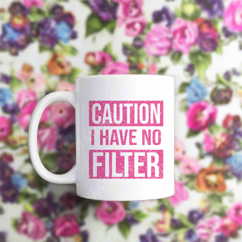 A coffee mug with the phrase "Caution: I Have No Filter" printed on it, emphasizing a bold and humorous attitude