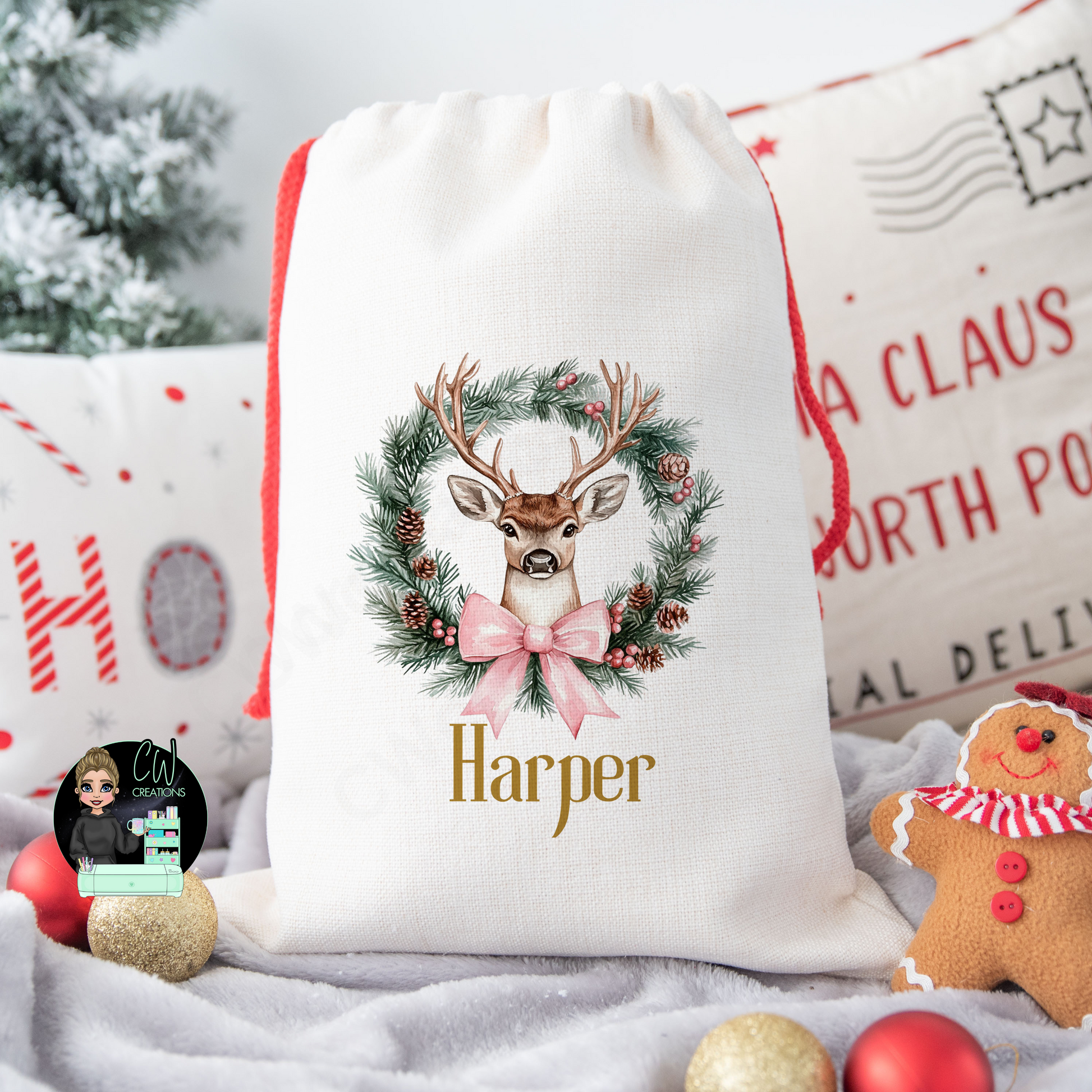 A linen Christmas sack with a Reindeer Wreath with a blue ribbon personalised with a name