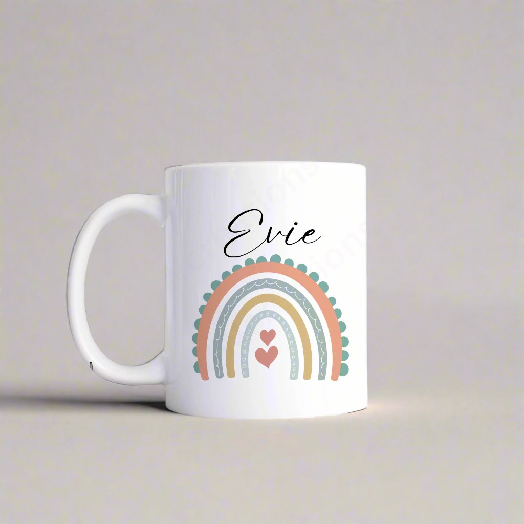 A white mug with a pastel coloured rainbow personalised with a name